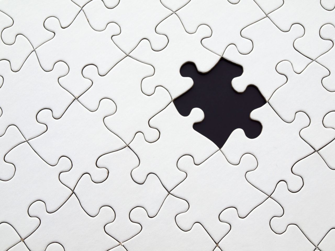 Home Close-up of an incomplete white puzzle with one missing piece, symbolizing challenge and strategy.